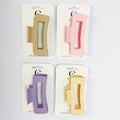 Large rectangular hair claw clips with cut-out centre; Matte plastic finish; Soft pastel colours including beige, pink, purple and yellow; Mounted on white branded hair accessories cards;