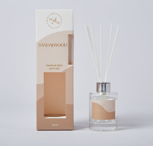 clear glass bottle with silver cap; white reed sticks; sandy beige and cream coloured packaging; label and box feature minimalist text and logo;