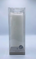 white pillar candle; plastic transparent packaging; cylindrical shape; label with size and flame icon;