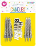 silver twisted candles; plastic holders; white 'Happy Birthday' cake decoration with black and silver lettering; yellow and white packaging with colourful confetti graphics;