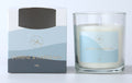 white wax candle in clear glass jar; blue label with gold text; candle weighs 120g; packaged in blue and grey cardboard box;