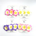 Foam frangipani flowers with gradient colouring; Flowers feature a small pearl bead at the centre; Mounted on white branded backing cards; Assorted colours including pink, yellow-white and purple tones;