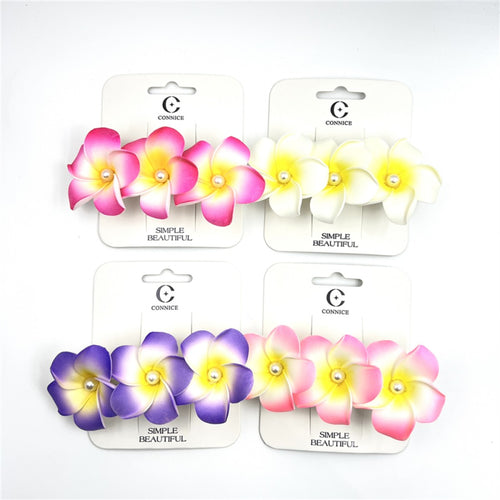 Foam frangipani flowers with gradient colouring; Flowers feature a small pearl bead at the centre; Mounted on white branded backing cards; Assorted colours including pink, yellow-white and purple tones;