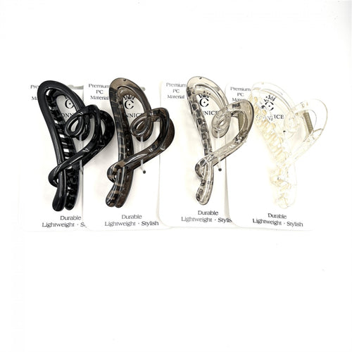 Heart-shaped claw clip design; Approx. 13cm long hair clip; Neutral colours including black, brown, grey and clear; Mounted on branded backing card; Curved, open-frame plastic construction;