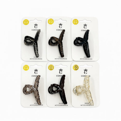 Long twist cross style hair claw clip; Mounted on white branded backing card; Clips shown in dark, tortoiseshell and clear tones; Curved teeth along the inner edge of the clip;