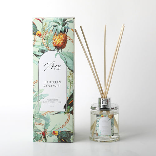 Clear glass bottle with silver metallic cap; Natural wooden reed sticks inserted; Light tropical design label on bottle and box; Box features pineapple and tropical foliage artwork;