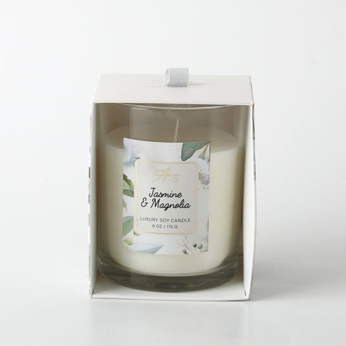 White wax candle in clear glass jar; Label with floral design and gold trim; Packaged in white box with floral accents; Single wick candle;