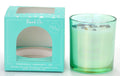 Green glass candle holder; White wax with embedded peacock ore stones; Teal coloured box packaging with window; Text on box highlighting confidence, prosperity, joy;