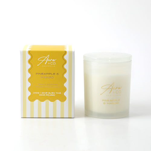Frosted glass jar and lid; Yellow and white packaging; Gold text label on jar and box; Square box with stripes and wavy edge design;