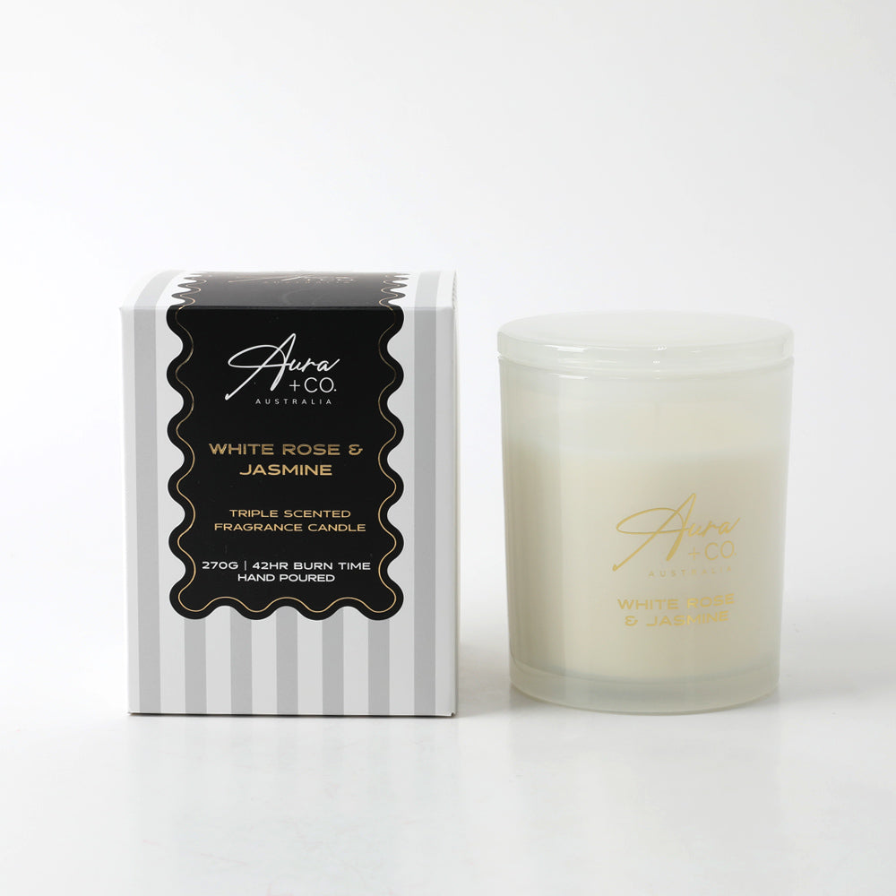 Frosted white glass container with lid; Gold lettering on glass; Black and white striped packaging with gold accents; Simple, elegant design;