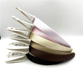 Wide satin-covered headbands; Approximate width of 2cm; Smooth, slightly glossy finish; Shown in assorted neutral and pastel colours;
