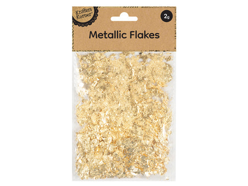 gold metallic flakes; 2 gram pack; clear plastic pouch packaging; kraft paper header with hole for hanging; brand name 'Krafters Korner' on label;