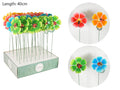 flower-shaped stakes; bright colours including green, blue, red, orange; metal stems; decorative ladybug on flower centre;