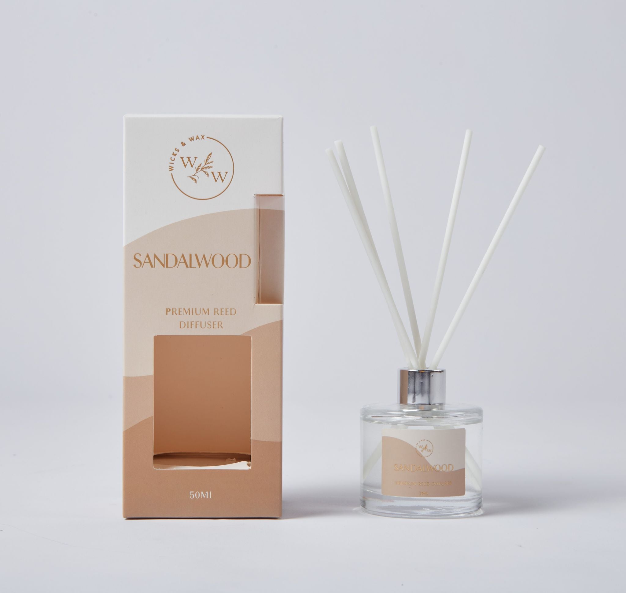 clear glass bottle; white reed sticks; beige label with wording; cardboard packaging with window; 50ml size indicated on packaging;