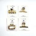 Gold-tone metal hair claw clips; Geometric open-frame designs in assorted shapes; Mounted on white backing cards labelled CONNICE Hair Accessories; Medium-sized claw style with visible teeth and hinge;