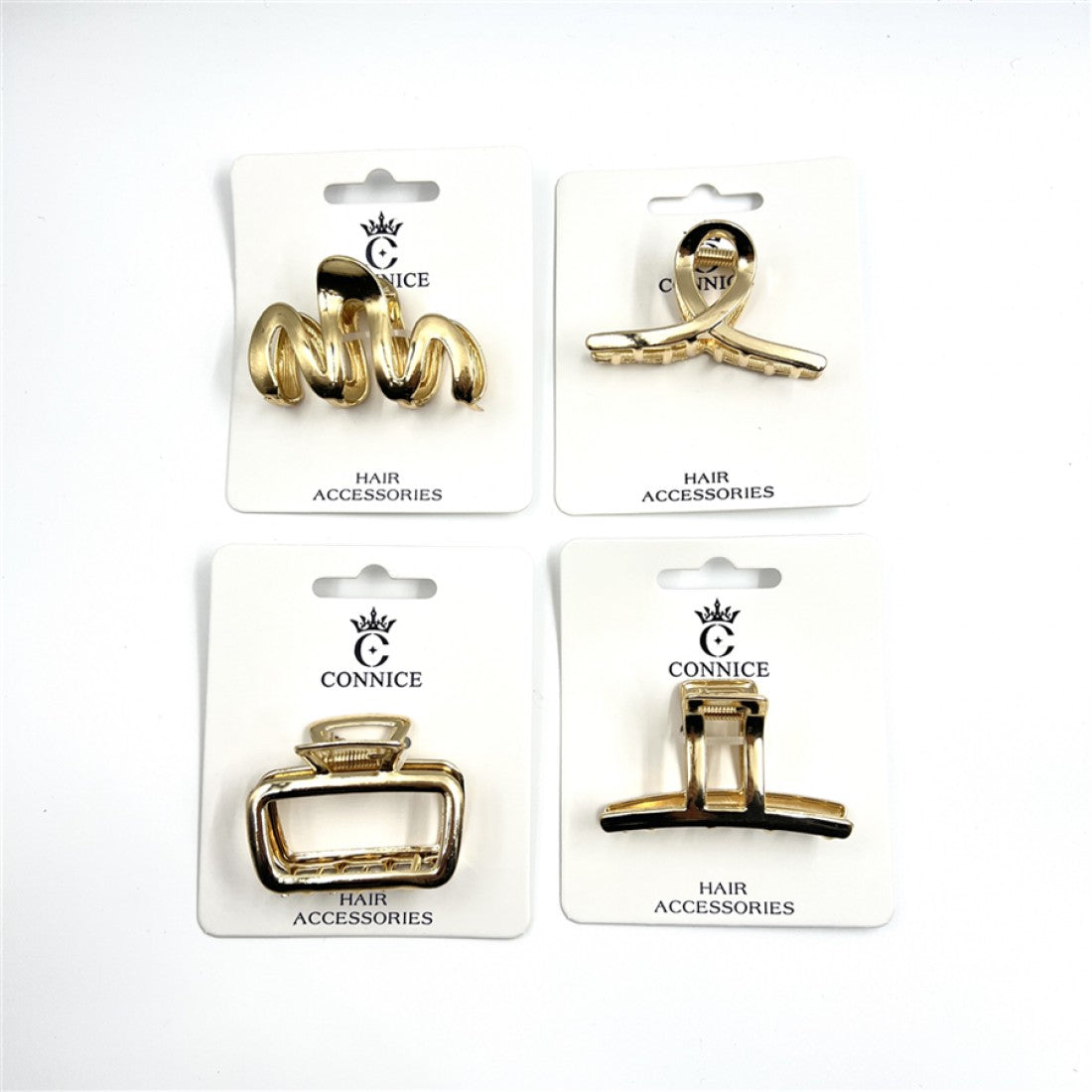 Gold-tone metal hair claw clips; Geometric open-frame designs in assorted shapes; Mounted on white backing cards labelled CONNICE Hair Accessories; Medium-sized claw style with visible teeth and hinge;