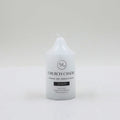 white colour; cylindrical shape with a peaked top; printed label with text; smooth wax surface;