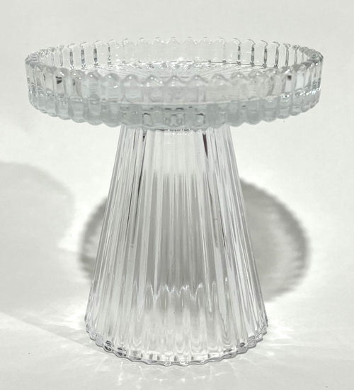 Clear transparent ribbed glass material; Short pedestal style candle holder; Circular top with ridged edge; Compact size approximately 9.8x9.7cm;