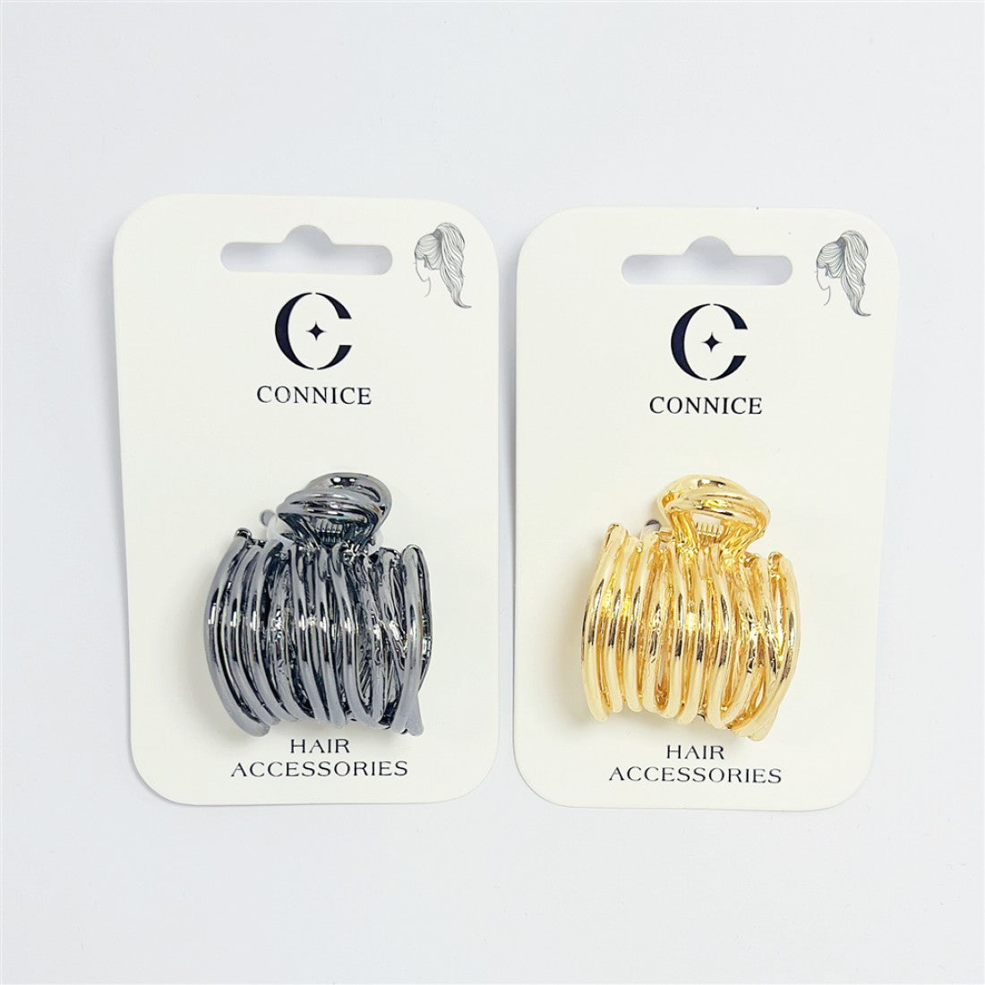 Small metallic claw clip with curved open prongs; High-gloss gold finish shown on one clip; High-gloss black or gunmetal finish shown on another clip; Mounted on white backing card branded "CONNICE"; Labelled as hair accessories on the packaging;