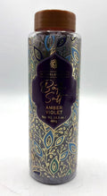 clear plastic jar; brown screw cap; purple label with gold and blue leaf design; purple coloured bath salts visible inside;