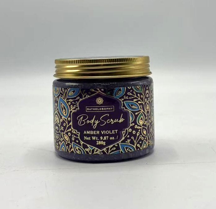 purple body scrub in jar; golden screw lid; decorative label with blue and gold leaf pattern; 280g size info on label;