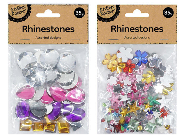 clear plastic packaging with cardboard header; variety of rhinestone shapes including flowers, stars, and gems; multiple colours including pink, purple, yellow, blue, green and clear; shiny and reflective surface;