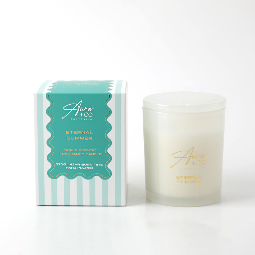 Frosted glass jar with matching glass lid; White coloured candle wax; Blue and white striped box with gold lettering; Gold Aura + Co branding on jar; Compact, cylindrical shape;