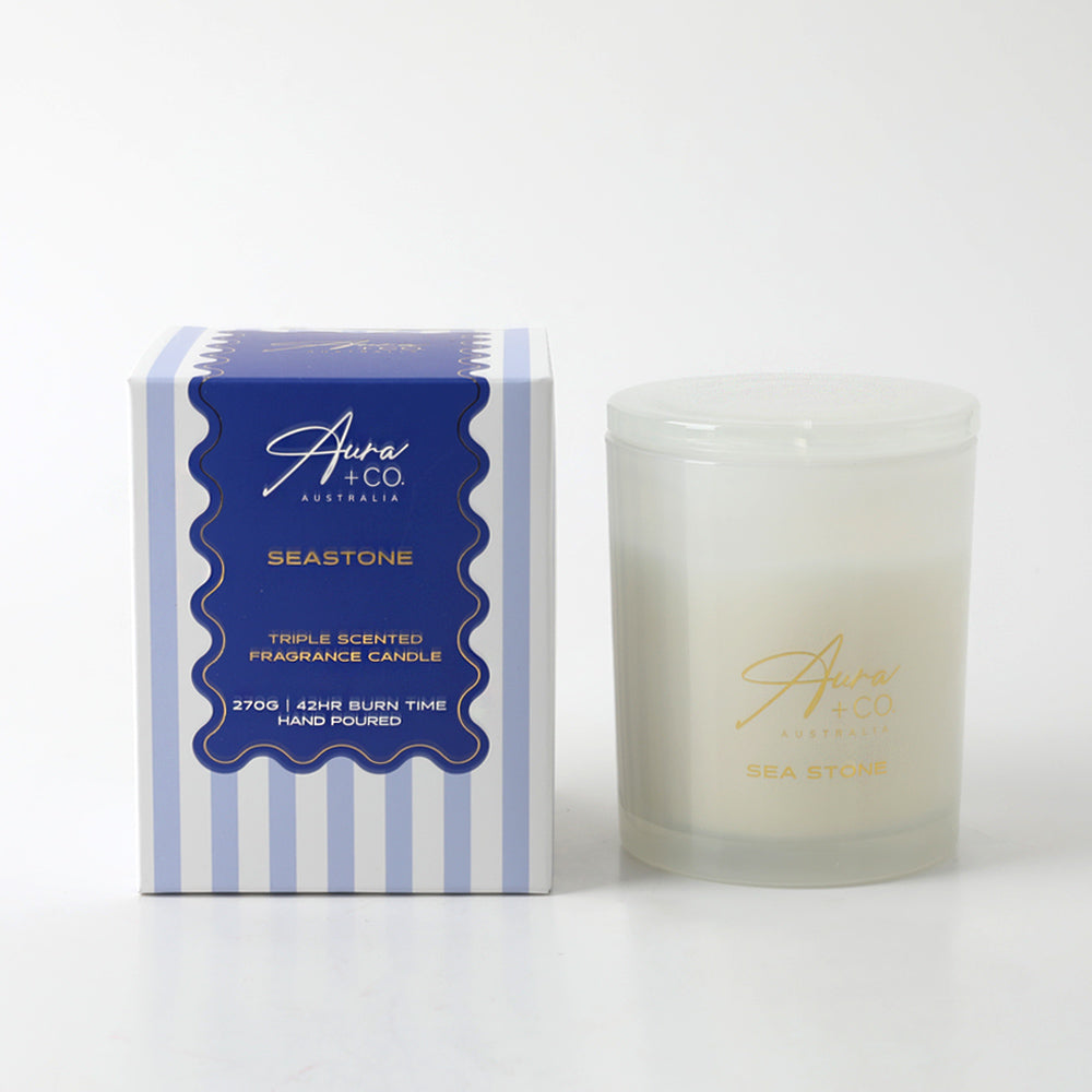 Frosted glass jar with glass lid; White candle wax; Blue and white striped gift box; Gold scripted brand and product name on jar;