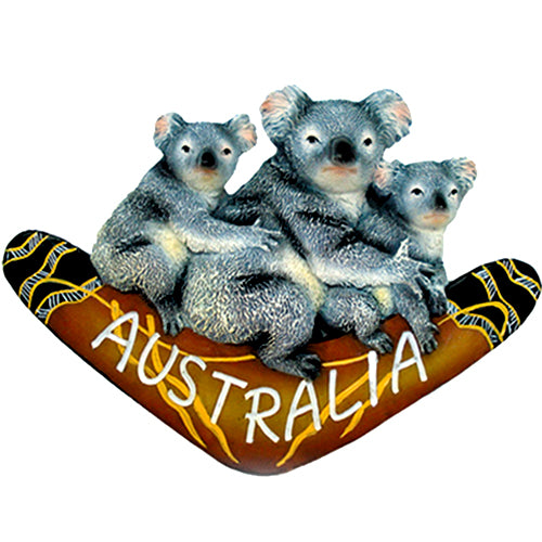 three koalas sitting on a brown boomerang; boomerang features painted Aboriginal-style designs; word 'AUSTRALIA' painted in white on boomerang; magnet likely comes in a single piece; resin material with detailed texture and colour;