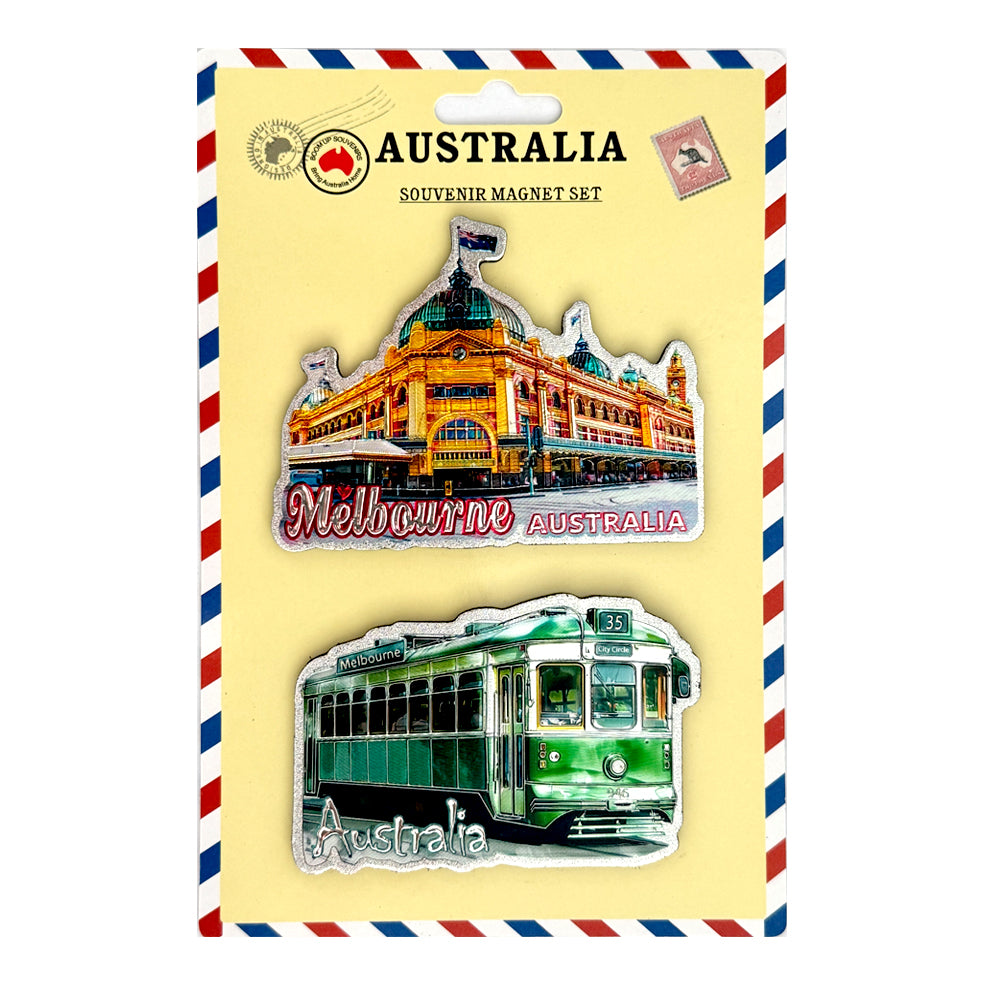 Two PVC magnets on yellow backing card; One magnet shows Melbourne building with flag; Second magnet shows green Melbourne tram with Australia text; Card backing has Australia themed graphic border; Bright, detailed colour prints on magnets;