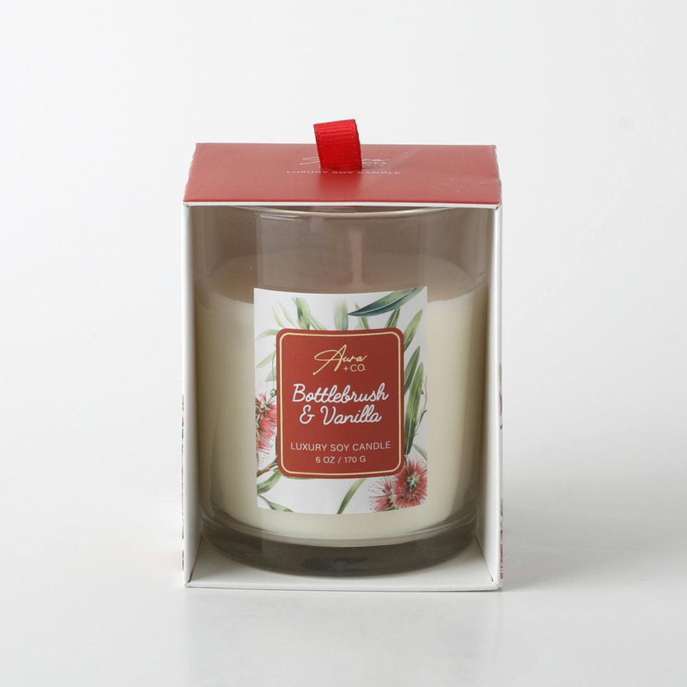 Clear glass jar container; Red top lid with pull tab; Label with bottlebrush floral design; White coloured candle wax; Packaged in box with open front;