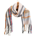 oversized check pattern; burnt orange, blue, beige, black, red colours; chunky plush texture; fringed ends; long rectangular shape;