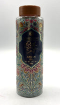Clear plastic cylindrical container; Brown twist-off lid; Decorative floral pattern in multiple colours; Blue label with gold text; Contains coarse bath salts inside;