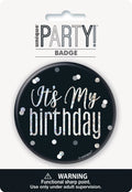 black circular badge; glittery silver text and dots; 'It's My Birthday' text; plastic material; pin-back fastening;