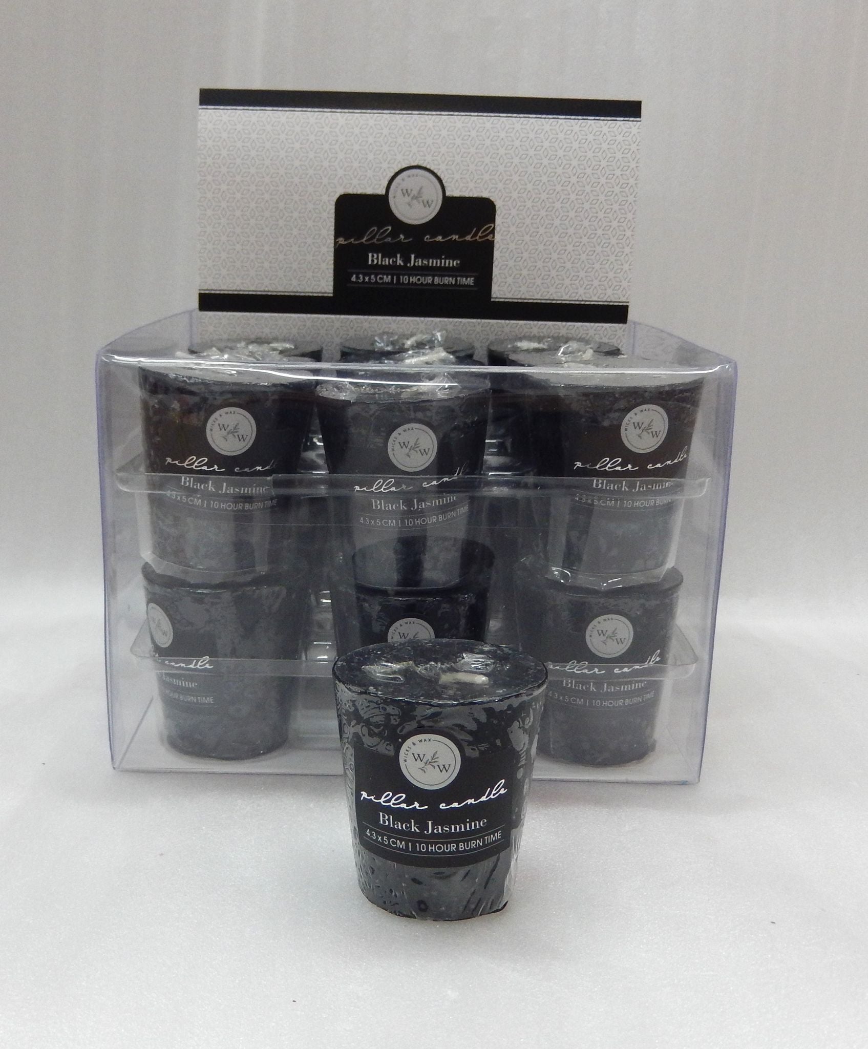 black votive candle; solid colour; label reads 'Black Jasmine'; cylindrical shape; transparent plastic packaging;