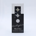 Black Rose scent; pack of 10 tealights; black and white patterned box; clear window showing tealights inside; 4 hour burn time noted on packaging;