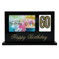 black glossy rectangular frame; gold "Happy Birthday" text; two display windows: one for 6x4 card, one for number 60; sturdy flat base; birthday-themed image with candles inside left window;