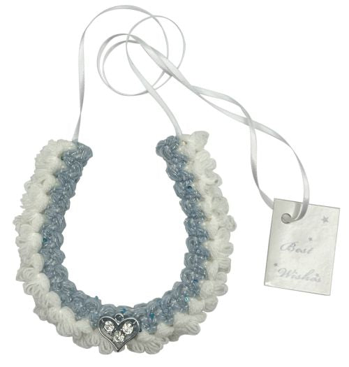 blue and white braided yarn horseshoe shape; silver heart ornament with clear stones; attached white hanging ribbon; handcrafted appearance;