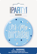 powder blue round badge; 7.6cm diameter; glitter text 'It's My birthday'; decorative multicolour confetti dots; plastic pin badge;