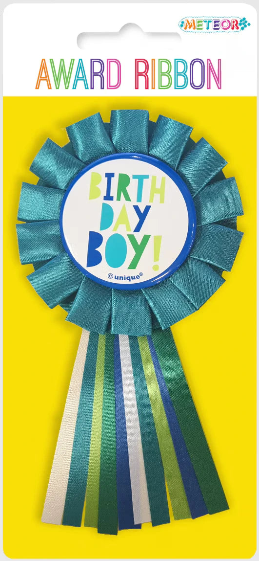 Blue and green ribbon with striped tails; Circular badge centre with "BIRTHDAY BOY!" text; Ribbon has a pleated rosette design; Attached to yellow backing card with 'AWARD RIBBON' text;