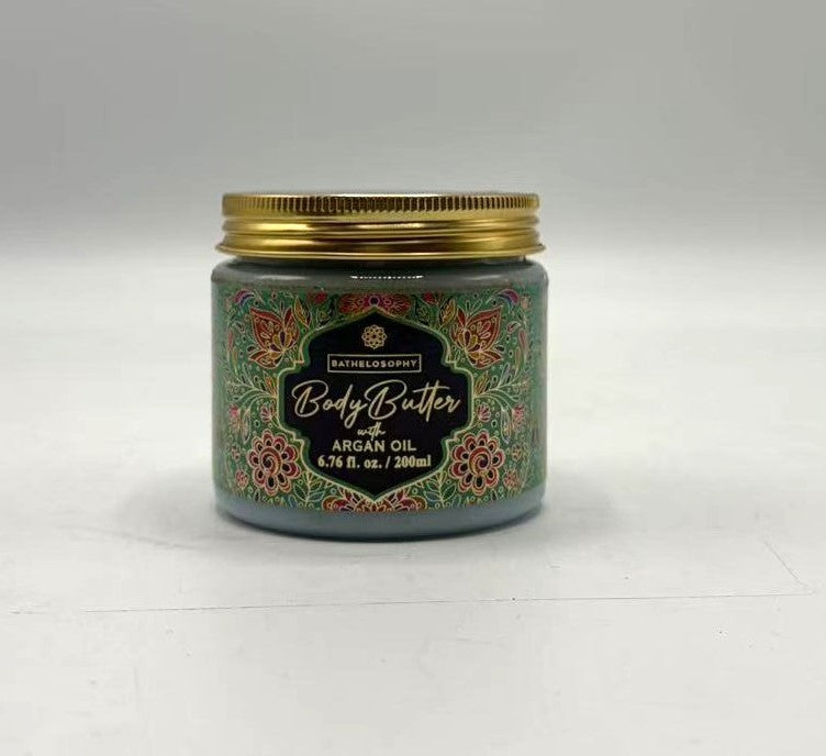 green decorative label with floral and paisley patterns; gold screw-top lid; glass jar; 200ml volume indicated on label;