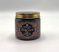 jar container with decorative floral label; gold screw-top lid; dark coloured scrub visible through glass; label includes cream and pink floral designs;
