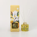 Yellow box with lemon and white flower illustrations; Glass diffuser bottle with matching lemon print; Gold collar on diffuser bottle; White diffuser reeds inserted into bottle;