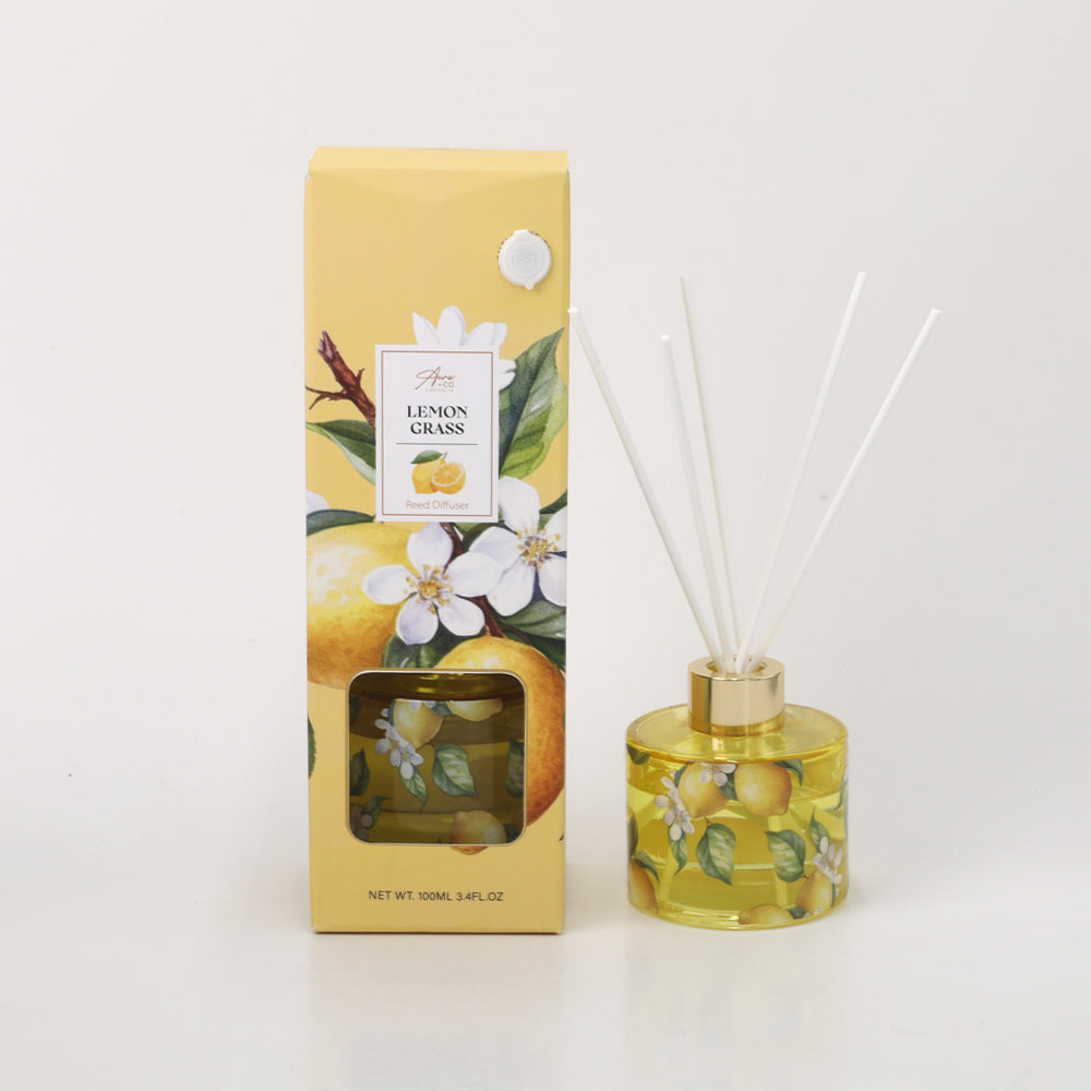 Yellow box with lemon and white flower illustrations; Glass diffuser bottle with matching lemon print; Gold collar on diffuser bottle; White diffuser reeds inserted into bottle;