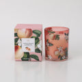 Pink glass candle holder; Decorative peach and white flowers print; Matching pink box with peach and flower design; 180g candle weight text on packaging;