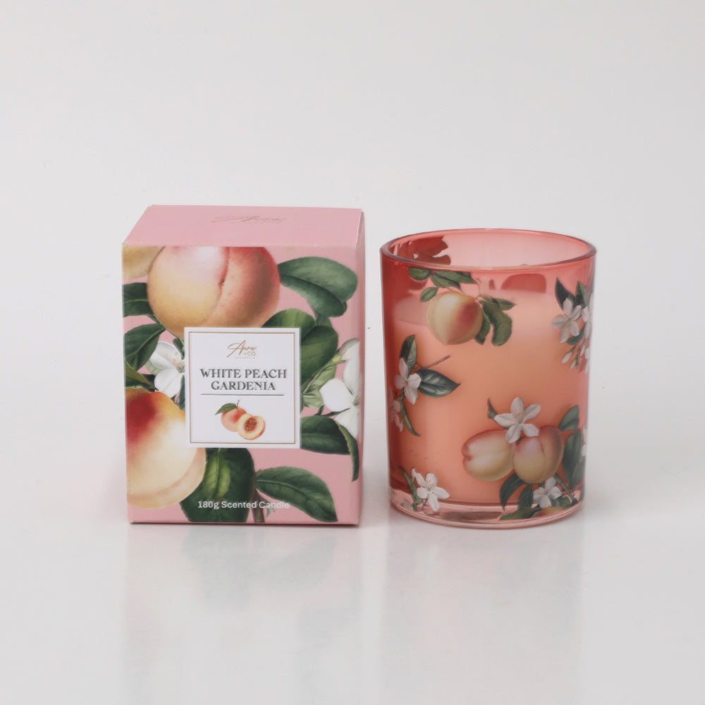 Pink glass candle holder; Decorative peach and white flowers print; Matching pink box with peach and flower design; 180g candle weight text on packaging;
