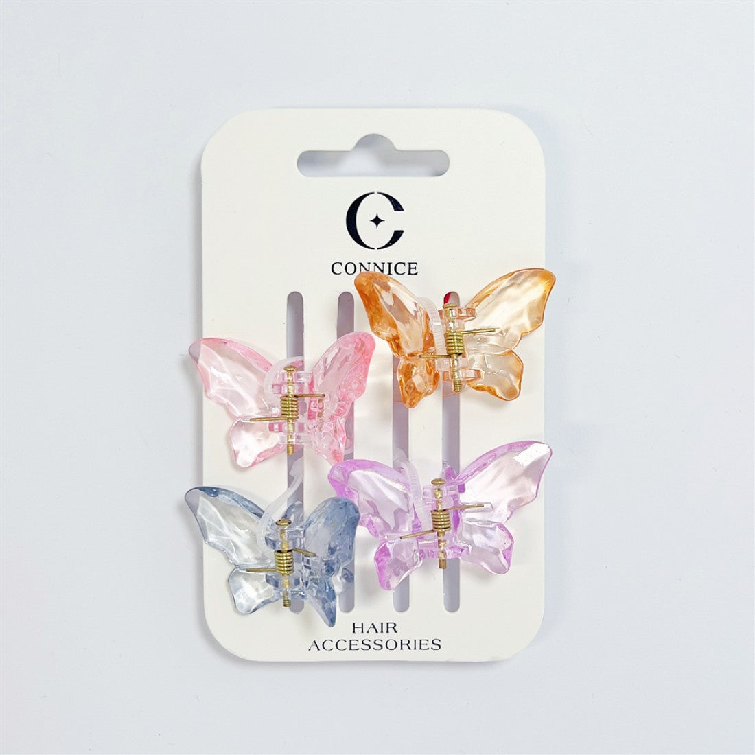 Set of four butterfly-shaped claw clips; Translucent plastic in pink, orange, purple and blue tones; Gold-tone metal springs and hinges; Mounted on white branded backing card labelled hair accessories;
