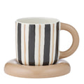 black and natural vertical stripe pattern on cup; round natural-coloured handle; smooth ceramic finish; matching natural-coloured rounded saucer;