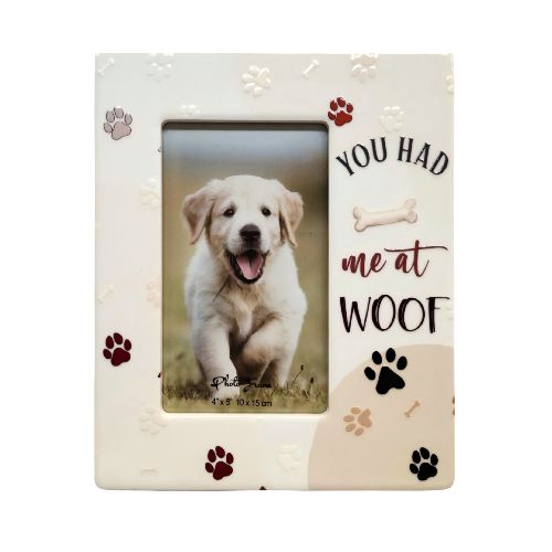 white ceramic frame; multicoloured paw prints in red, brown, black, beige; text saying 'You had me at Woof'; bone illustration; holds 4x6 inch photo;
