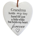 white heart-shaped ceramic; black printed sentimental text; glossy finish; brown leather-style hanging loop;